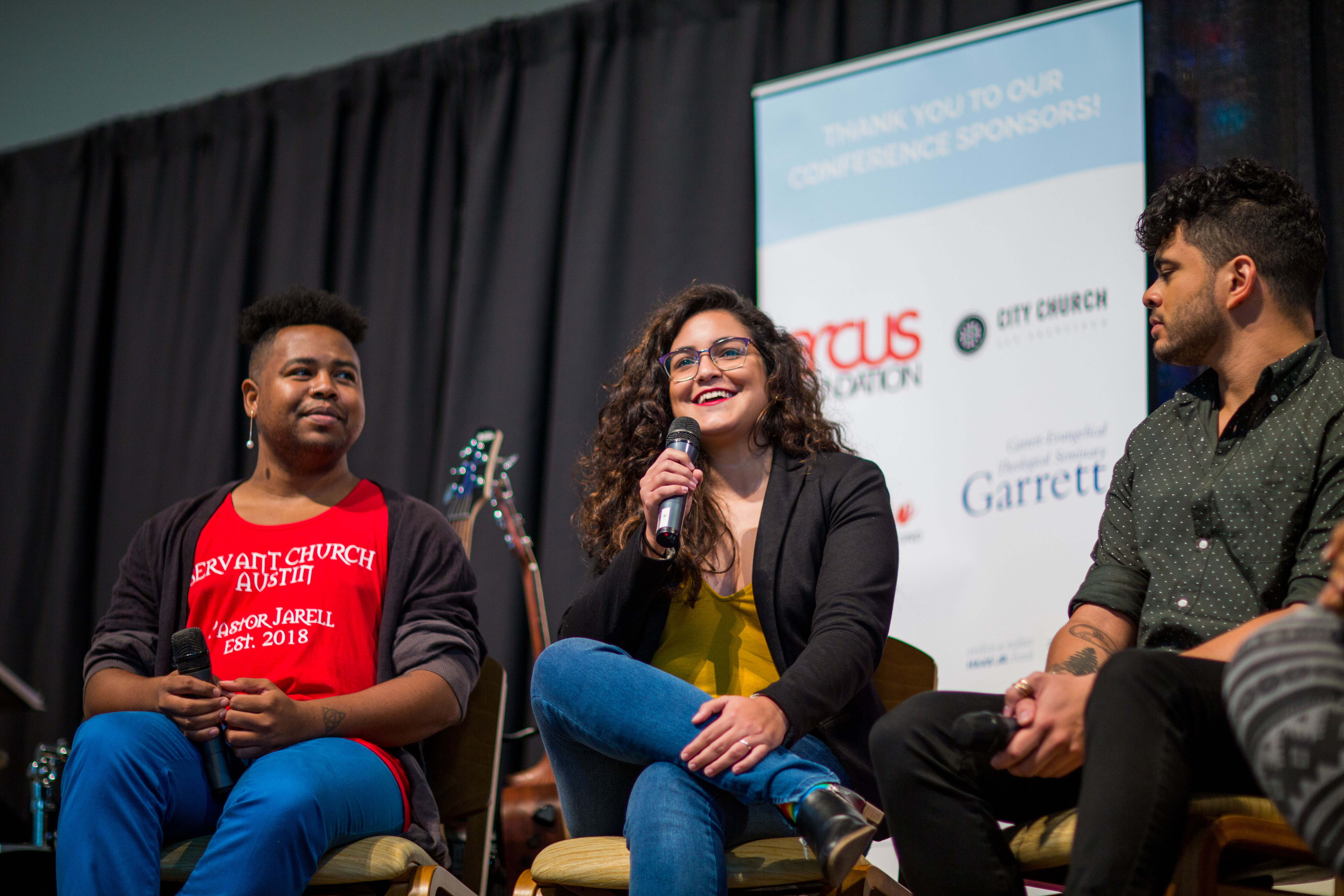 Jarell, Carla Sofia, and Michael speak on the stage